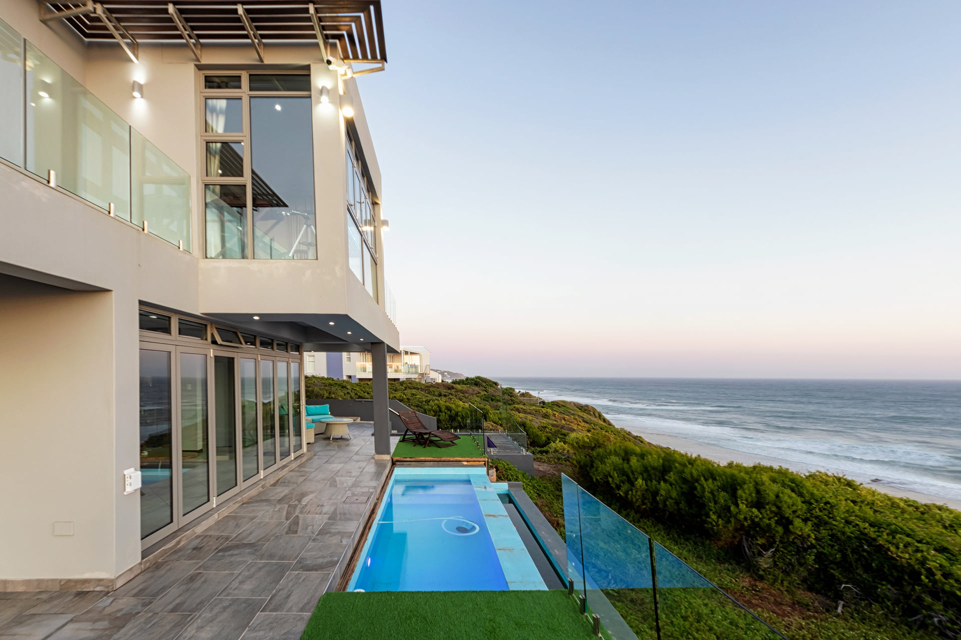 Pool terrace with a sea view at a coastal home
