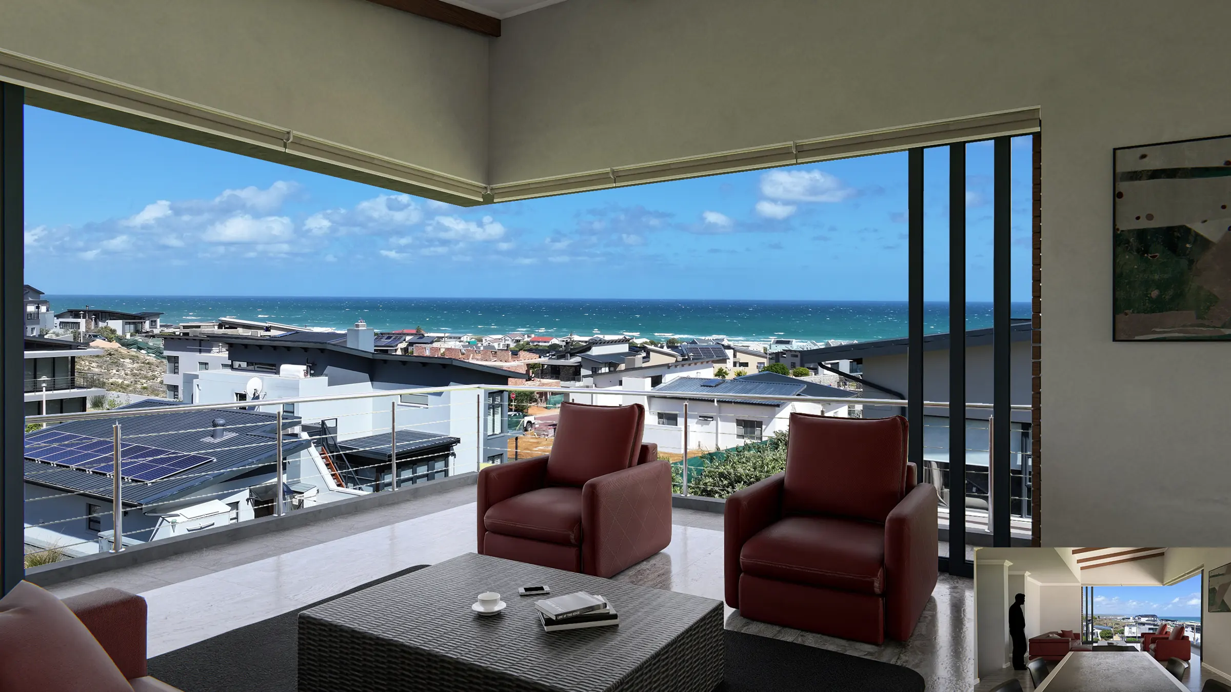 Lounge with sliding doors opening onto a sea view at Huis Serfontein